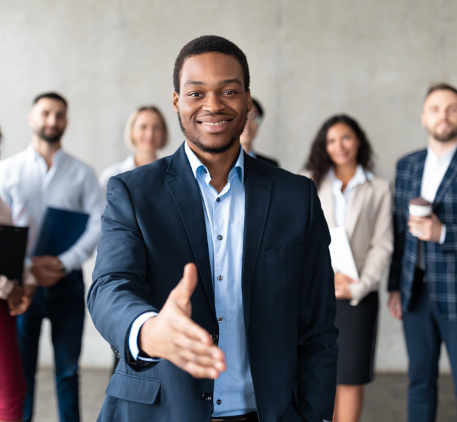 Man reaching out for a handshake, symbolising a warm welcome during sales onboarding.